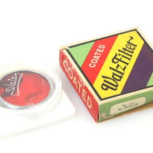 May include: A red coated Walz filter in a white plastic case with a yellow and green box that says "COATED Walz Filter No. 121 for IKOFlex RED".