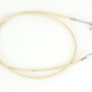 May include: A clear plastic tube with a metal tip and a metal handle. The tube is coiled and the handle is attached to the end of the tube.