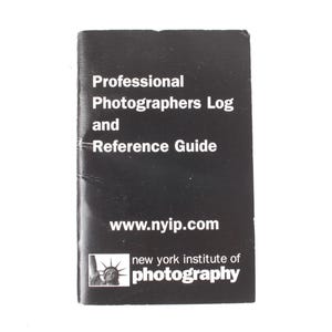 May include: A white ceramic mug with a black handle and the text "But First, Coffee" in a bold, black font. The mug is filled with a dark liquid, likely coffee, and sits on a white surface.
