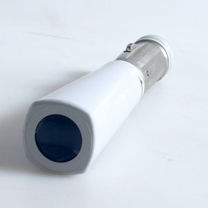 May include: A white and silver security camera with a round lens. The camera is designed to be mounted on a wall or ceiling.