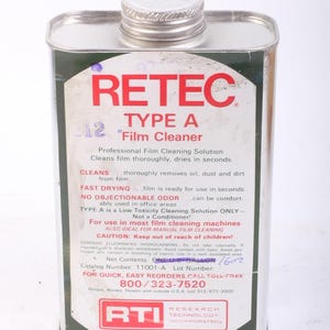 May include: A white metal can with a red label that reads "RETEC TYPE A 12" Film Cleaner". The label also includes information about the product, such as its use as a professional film cleaning solution and its fast drying time. The can is labeled "RTI Research Technology Incorporated".