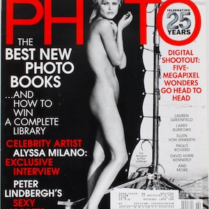 May include: A magazine cover for American Photo, featuring a black and white photograph of a nude woman. The cover has red text reading "AMERICAN PHOTO" and headlines about photography books, celebrity interviews, and digital cameras.