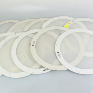 May include: A set of ten white round diffusers, likely for lighting fixtures. The diffusers are made of a translucent material and have a smooth, slightly textured surface.