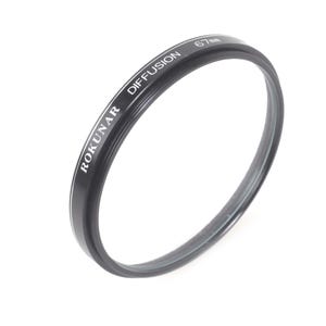 May include: A black Rokunar Diffusion 67mm camera lens filter. The filter has white text that reads "ROKUNAR DIFFUSION 67mm". The filter is circular and made of metal and glass. The filter is designed to soften images.