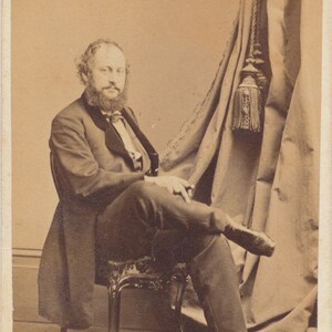 Sitting Man Smoking a Cigar Next to Large Curtains. CDV. Philadelphia, PA, USA.