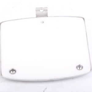 May include: A white, rectangular object with rounded corners and a silver metal frame. Two silver rivets are visible at the bottom, and a metal bracket is at the top. The object appears to be a component or part.