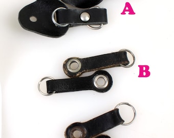 May include: Three black leather strap loops with metal rings. The loops are labeled A, B, and C.