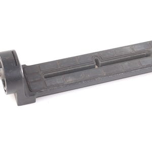 May include: A black, rectangular camera accessory with a textured surface and a silver metal screw. The accessory has a cylindrical base and a long, grooved body. The item is designed to attach to a camera.