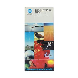 May include: A blue and white brochure with the text "Quick-Reference Guide" and "Minolta" on the front. The brochure features a collage of images, including a bird, a zebra, a sunset, and a ballerina.