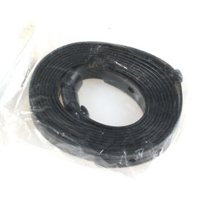 May include: A black rubber strap with a buckle, coiled and packaged in a clear plastic bag.