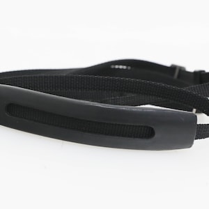 May include: Black camera strap with a padded handle.