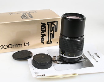 Objetivo telefoto Nikon Nikkor 200 mm F4 AI, en caja con tapas
