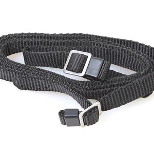 May include: Black camera strap with a silver metal buckle and a black plastic adjuster.
