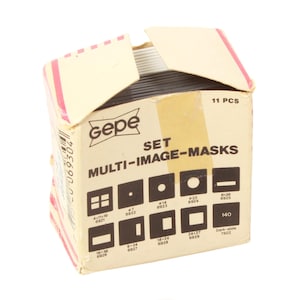 May include: A vintage box of Gepe Multi-Image Masks, featuring various shapes and sizes. The box is beige with red accents and displays the product name and a diagram of the masks. The box contains 11 pieces.