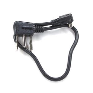 May include: A black power adapter with two angled connectors and a connecting cable. The adapter has two prongs and a small hole on the connector. The cable is curved and has a smooth texture.