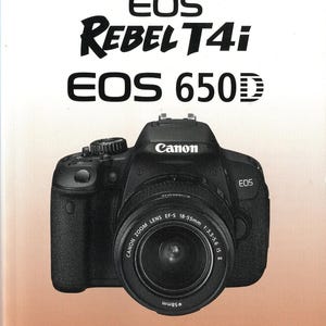 May include: A Canon EOS Rebel T4i EOS 650D digital camera with a zoom lens. The camera is black with the Canon logo and lens specifications visible. The image also includes the Canon logo and the word "INSTRUCCIONES".
