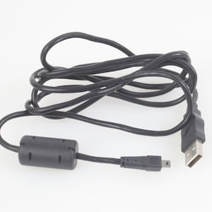 Könnte beinhalten: Ein schwarzes USB-Kabel mit einem USB-A-Anschluss und einem Micro-USB-Anschluss. Das Kabel ist aufgerollt und hat einen Ferritkern in der Nähe des Micro-USB-Endes. Die Anschlüsse sind schwarz.