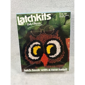 May include: A Latchkits by Betty Wilkinson craft kit box featuring an owl design with round glasses. The box displays the text Latchkits, LH 101 OWL, 10 x 10 approx. finished size, and latch hook with a new twist. The owl has black, brown, yellow, and white yarn.