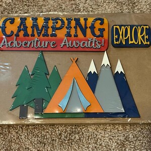 May include: A camping-themed wooden sign with the words "CAMPING Adventure Awaits!" and "EXPLORE." The sign features a tent, trees, and mountains in various colors, including orange, green, and blue.
