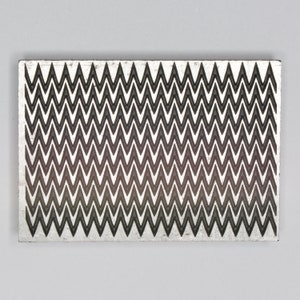 May include: A rectangular silver-colored metal plate with a repeating pattern of black and white chevron shapes. The chevron pattern creates a gradient effect, with the black chevrons becoming more prominent towards the bottom of the plate.