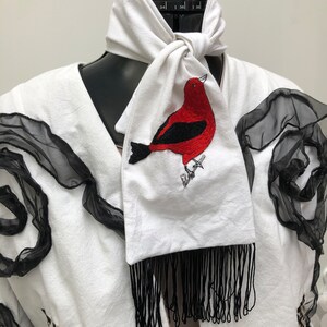 White cotton scarf with hand-embroidered Red Tanager bird motif with black tassels