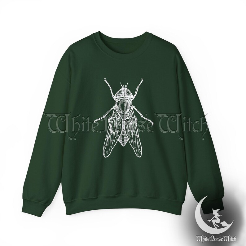 May include: A dark green sweatshirt with a white illustration of a fly on the front.