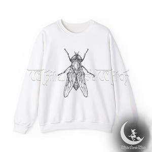 May include: White sweatshirt with a black and white illustration of a fly on the front.