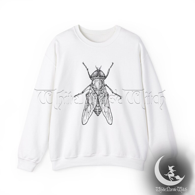 May include: White sweatshirt with a black and white illustration of a fly on the front.