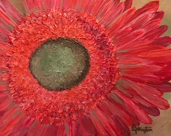 May include: Close-up of a red gerbera daisy with a dark green center. The petals are textured and have a slightly iridescent sheen.