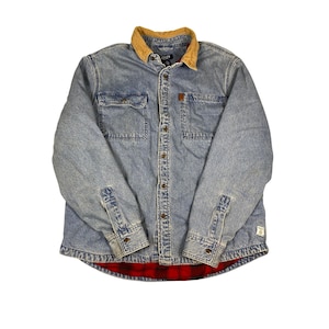 May include: A light blue denim button-down shirt featuring a tan corduroy collar, two chest pockets with button closures, and a red and black plaid flannel lining. The shirt has long sleeves with buttoned cuffs and a small brand label on the chest.