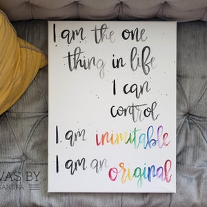 May include: White canvas art with handwritten text in black, gray, and rainbow colors. The text reads "I am the one thing in life I can control. I am inimitable. I am an original." The artist's name, "Canvas by Cassandra," is at the bottom.
