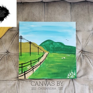 May include: A painting of a green field with a dirt road leading up to a green hill. There are power lines and a wooden fence along the road. The sky is blue with white clouds. The painting is signed "Canvas by Cassandra".