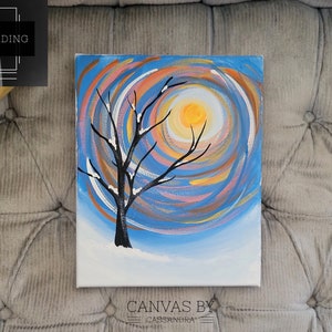 May include: A painting of a winter scene with a bare tree in the foreground and a bright yellow sun in the background. The sky is painted in shades of blue, pink, and orange, with swirling lines creating a sense of movement. The tree is silhouetted against the sun, and the snow is painted in white.
