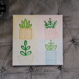 May include: A square canvas painting with four different plant illustrations. Each plant is in a different colored pot. The top left plant is green with a yellow pot. The top right plant is green with a pink and white polka dot pot. The bottom left plant is green with a white and yellow pot. The bottom right plant is green with a blue and white striped pot. The canvas is signed "Canvas by Cassandra".