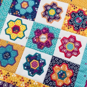 May include: A quilt block with a patchwork design featuring a variety of colorful hexagonal flowers. The flowers are surrounded by a white background and a border of yellow, teal, and purple fabric. The text "Pixie Willow Patterns" is visible in the center of the block.