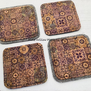 May include: Set of four cork coasters with a patterned design of brown, gold, and purple tiles. The coasters are backed with gray felt.