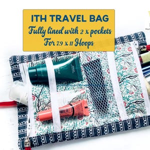 May include: A floral patterned travel bag with a navy blue border, containing beauty products. The bag has a mesh pocket and two zippered compartments. Text on a yellow banner reads "ITH TRAVEL BAG".