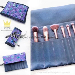 Puede incluir: Un rollo de brochas de maquillaje de tela morado y azul con una cinta blanca y negra. El rollo está desenrollado para mostrar las ranuras individuales para las brochas. El texto "Pixie Willow Patterns" es visible en la tela.