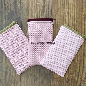 May include: Three pink quilted zippered pouches with different stitch patterns. The pouches are on a wood background. The text "Pixie Willow Patterns" is visible on the middle pouch.