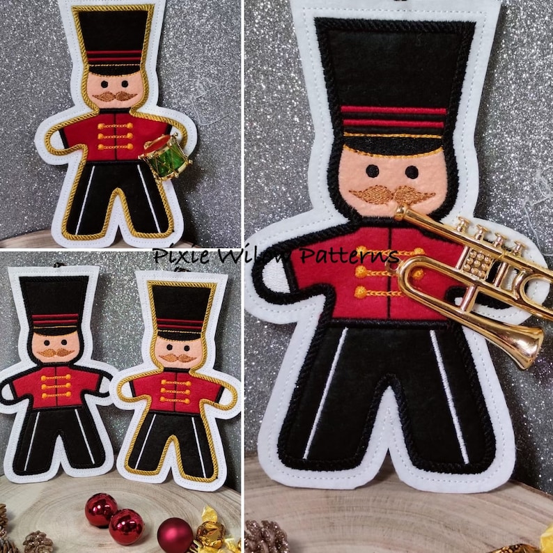 May include: Three felt ornaments shaped like gingerbread men, one playing a trumpet, one holding a drum, and one with no instrument. The ornaments are decorated with red, black, and gold details. The ornaments are on a white background.