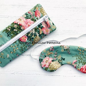 May include: A green floral eye mask and matching zipped pouch. The eye mask has a white elastic strap. The pouch has a white zipper and a pink tassel.