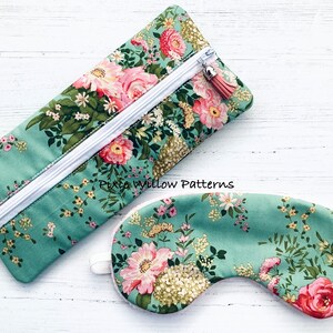 May include: A green floral print eye mask and matching zipped pouch. The pouch has a white zipper and a pink tassel. The text "Pixie Willow Patterns" is printed on the pouch.
