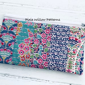 5x7 In the hoop Quilted Zipper bag pattern. Embroidery machine design of a zipper pouch with vertical quilt panels and sashiko stitching