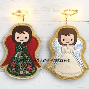 Peut inclure: Deux décorations d'ange de Noël. L'une a des ailes rouges et une robe verte à motifs floraux, l'autre a des ailes argentées scintillantes et une robe crème. Les deux ont des cheveux bruns, une bordure dorée et un halo. Pour la décoration.