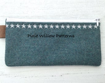 May include: A teal blue zippered pouch with a white star trim and the text "Pixie Willow Patterns" embroidered on the front.