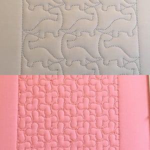 May include: Two fabric samples with different quilting patterns. The top sample is gray with a repeating pattern of stylized dogs. The bottom sample is pink with a repeating pattern of curved shapes.