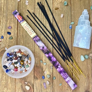 May include: A pack of HEM Precious Lavender incense sticks with a purple and white floral design. The box reads "HEM Precious Lavender" and "A delightfully fragrant incense that soothes and refreshes the senses".