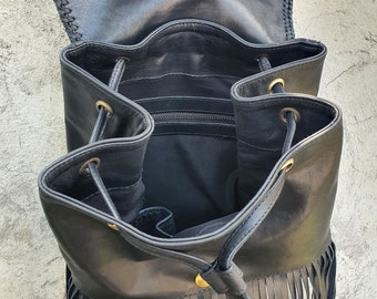 a backpack or a worn-in leather bag perhaps with fringe Black Leather Fringe Backpack, Leather Purse