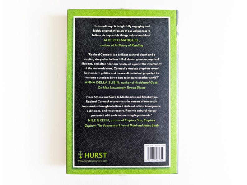 May include: A hardcover book with a bright lime green border and a textured black central panel. The back cover features printed testimonials in white and lime green text, a barcode, and the Hurst Publishers logo with their website address.