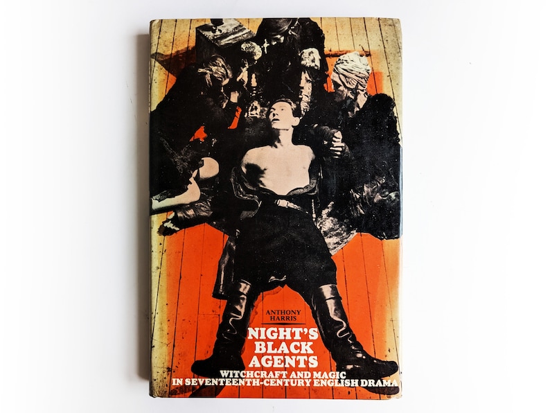 May include: A book cover with a black and white illustration of a person surrounded by other figures. The background is orange and the title is "Night's Black Agents: Witchcraft and Magic in Seventeenth-Century English Drama" by Anthony Harris.
